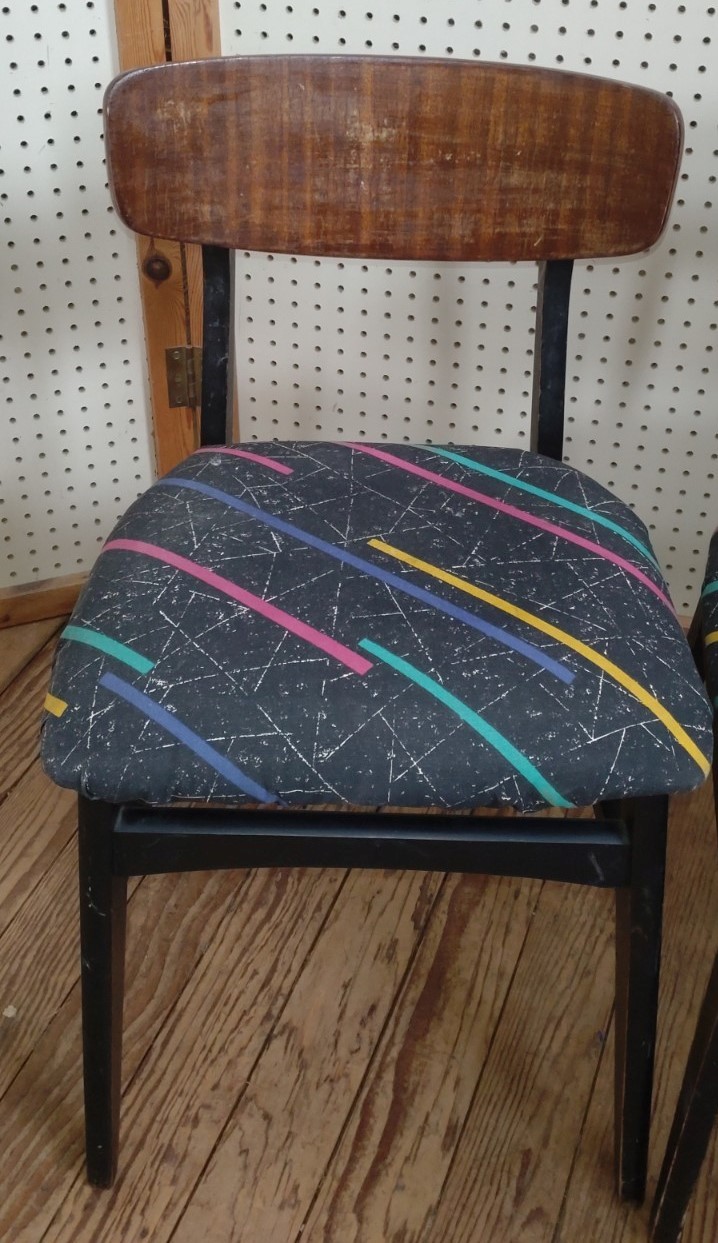 Four mid-century dining chairs, reupholstered with 80's design fabric.