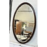 An oval mirror. Circa 1930. 73 x 46cm