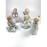 Two Lladro figure groups of girls with cats and two figure groups of girls with dogs 14cm to 18cm