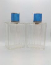 A pair of cut glass silver gilt and blue enamel scent bottles. Early 20th century. 13cm high.