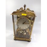 A Vintage Mantel Clock. With rotating ball pendulum. The silvered dial with Arabic numerals.