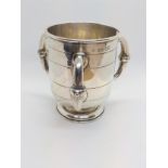 A Victorian three-handled tyg cup, London 1872. 10cm high. 192gms.