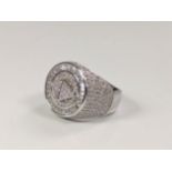 A large silver dinner ring set with several white round cubic zirconia. Size Q.