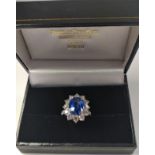 An 18ct white gold large oval sapphire and Round Brilliant Cut diamond cluster ring and shoulders,