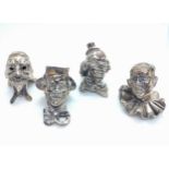 Four Continental silver-coloured metal cast masks. 3.5cm high. Some bear continental marks. 190.