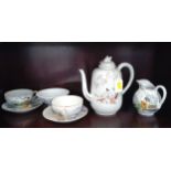 An Oriental teapot, jug, bowl and two teacups and saucers (chip in rim of jug)