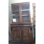 A Victorian Mahogany Bookcase. Circa 1850. Fitted with a pair of glazed doors enclosing shelves. All