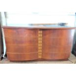 A mahogany veneered mid-century Sideboard. the double dome front fitted with drawers. 75cm x 135cm x