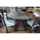 An Antique gateleg table (73 x 117 x 142 cm) together with five floral patterned cushioned chairs
