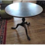 A George III Mahogany tilt top table. 18th century. with down swept supports and pad feet.