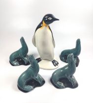 A Poole Penguin, 20.5cm, and four seals. (5)