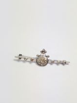 A diamond brooch set in high cart white metal. 50mm long. 3.65 grams.