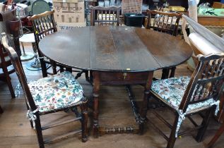 An Antique gateleg table (73cm x 117cm x 142 cm) together with five floral patterned cushioned