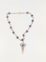 An Amethyst and white stone set necklace. Early 20th century. 24cm drop.