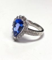 An 18ct white gold dress ring set with mixed pear-cut tanzanite and Round Brilliant Cut diamond halo