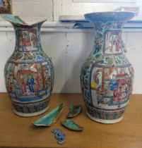 A pair of Chinese porcelain famille-rose vases decorated with panels of figures, 43cm, both with