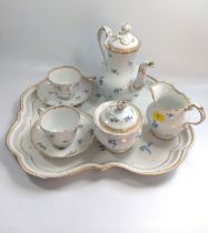 A German porcelain coffee set on tray with blue crossed sword Meissen marks one cup handle detached.