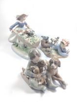 Lladro girl with wheelbarrow and two puppies, baby with dog and puppies, and boy with dog and