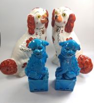 A pair of Spaniels numbered 4561 30cm and a pair of Oriental turquoise Buddhist Lions 25.5cm. (4)