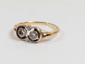 An Art Deco two-stone diamond ring, size O. 2.40 grams.