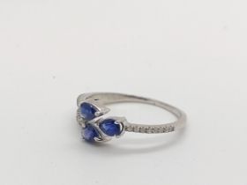 A silver trident-style ring set with three pear-shaped sapphires and round cut diamonds. Sapphires