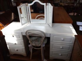 A white dressing table with three drawers each side, and triple vanity mirror. 77cm x 149cm x 48cm