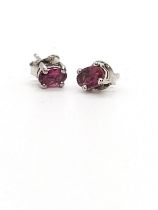 A pair of pink tourmaline studs in silver.