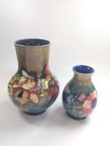 Two Moorcroft floral vases 16cm to 22cm.