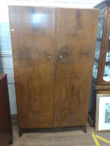 A two-door 1930's gentleman's wardrobe, walnut veneer by Brennan & Son, Guernsey. 183cm x 109cm x