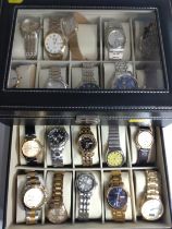 Twenty fashion watches in a presentation case.