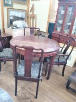 A Vintage Chinese Rosewood Circular Dining table with extension leaves and 10 chairs. Two of which