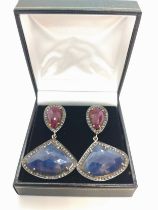 A large and impressive pair of double drop earrings set with pear-shape rose-cut rubies and