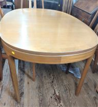 A mid-century oval light oak dining table. Circa 1960