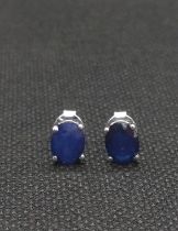 A pair of blue gemstone studs in silver, possibly kyanite.