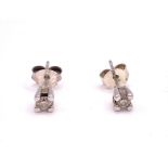 A pair of 9ct white gold mounted solitaire diamond ear studs, the round brilliant-cut diamonds of