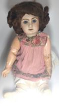 A Jumeau bisque head doll with glass eyes and jointed composition body, impressed 12 at rear of