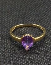 A 9ct yellow gold and amethyst dress ring, set with a mixed pear-cut amethyst.