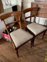 A pair of Victorian mahogany bar-back dining chairs, with beige upholstered seats, stylised legs,