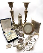 A pair of silver candlesticks, hallmarked 1906 (tarnished), filled bases, together with three