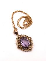 A Victorian yellow metal, amethyst, and pearl pendant, centered with a mixed oval-cut amethyst