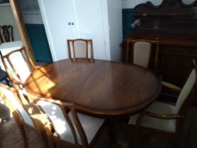 A Meredew extending dining table and six chairs (including two carvers). 74cm x 148cm x 95cm,