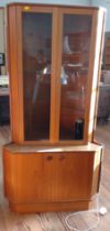 A mid-century flat-front corner unit with glazed upper doors. 170cm x 86cm x 54cm.