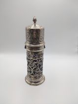 A silver sugar sifter, with pierced decoration, and blueglass liner, dated London 1904, bearing