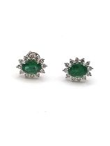 A pair of 18ct white gold, diamond, and emerald oval cluster ear studs, 11 x 9.5 mm, the emeralds of