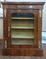 A glass front bookcase, with brass mounted decoration, glass fronted door with cream shelved