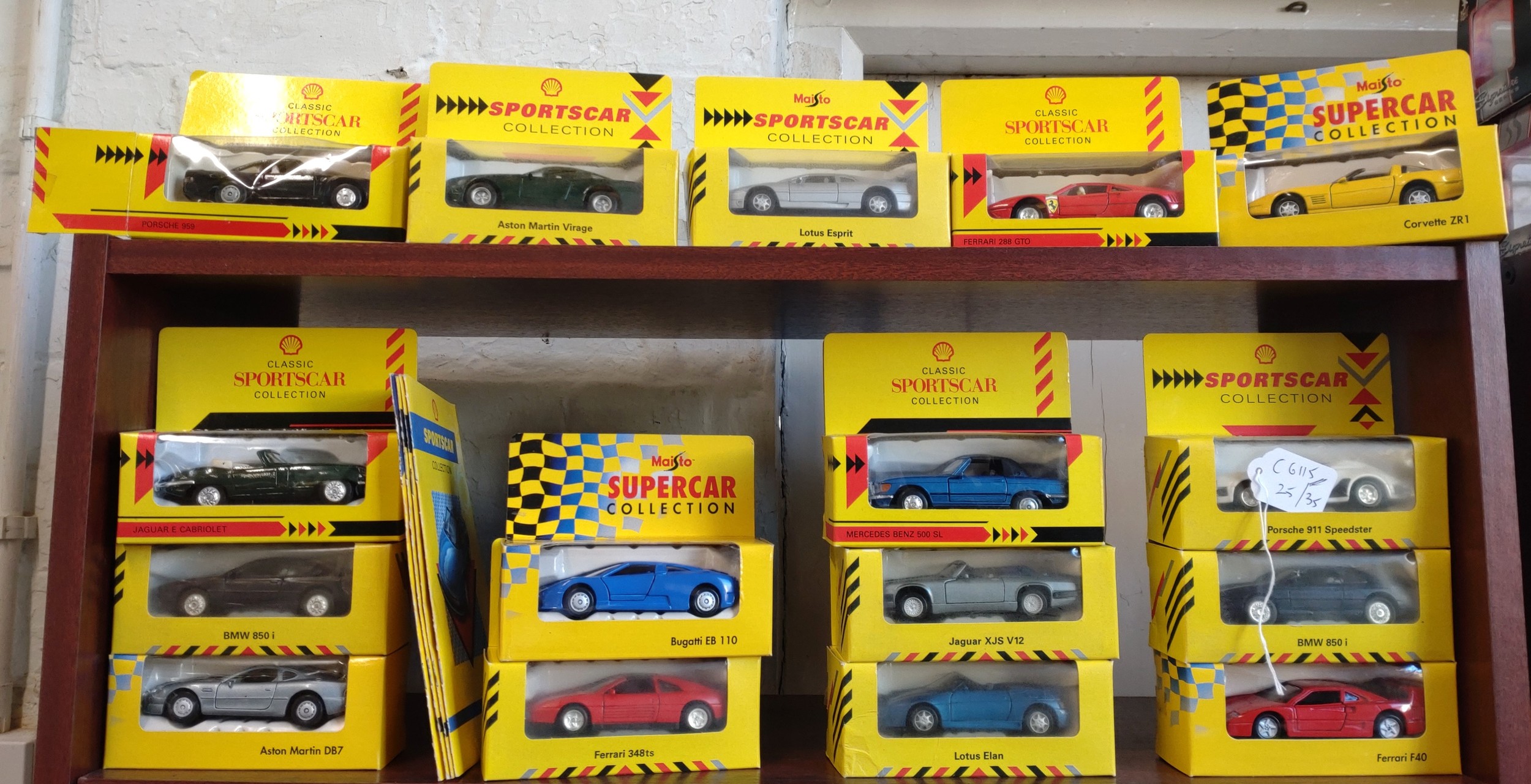 Shell and Maisto Sports Car Collection models including Aston Martin DB7 and Lotus Elan in window