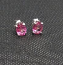 A pair of pink topaz studs in silver.