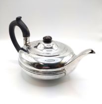 An Edwardian silver teapot, of squat circular design, hallmarked Chester 1904, engraved with