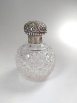 A cut-glass and silver perfume bottle 12cm approx.