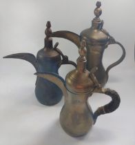 A group of three brass coffee pots, 26cm to 29cm.